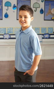 Portrait Of Male Primary School Pupil Standing In Classroom