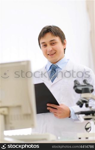 Portrait of male researcher with clipboard in hand