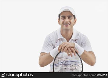 Portrait of male tennis player with racket isolated over white background