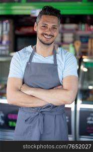 portrait of male worker outside his ice-cream parlour