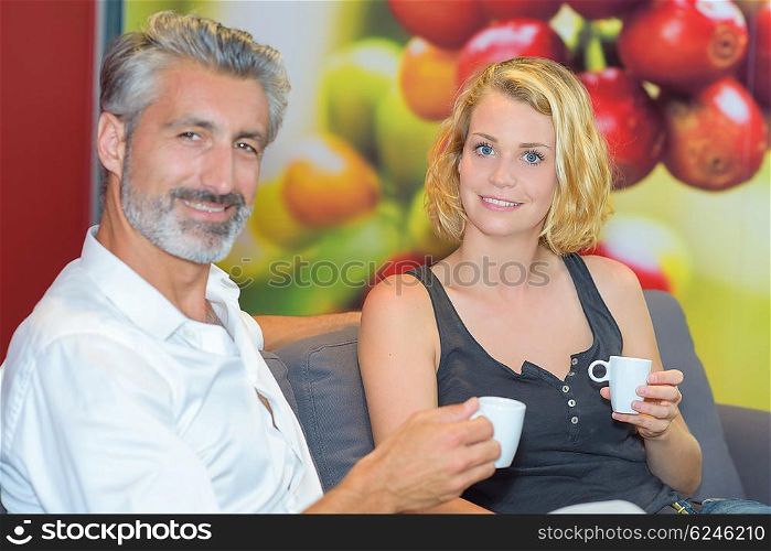 Portrait of man and lady holding cups