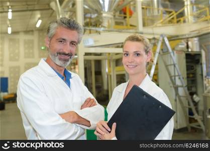 Portrait of man and woman in factory