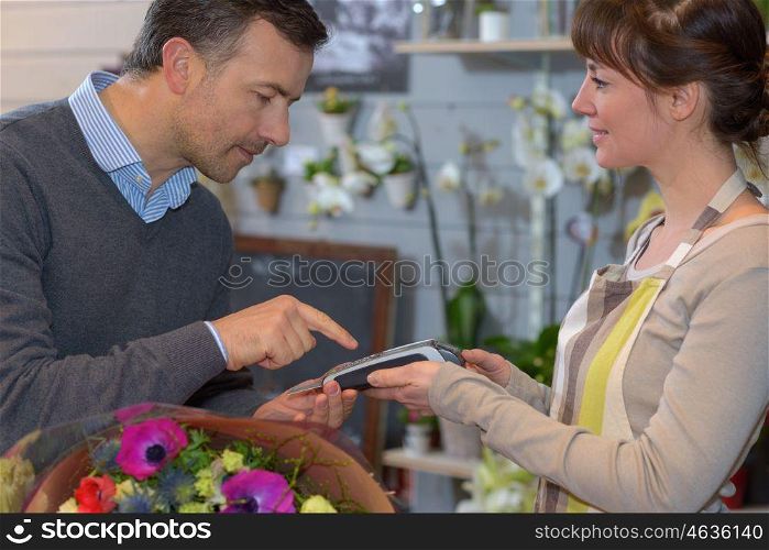 portrait of man buying flowers