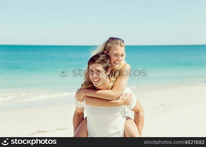 Portrait of man carrying girlfriend on his back. Portrait of man carrying girlfriend on his back on the beach