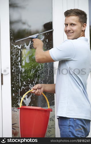 Portrait Of Man Cleaning House Windows