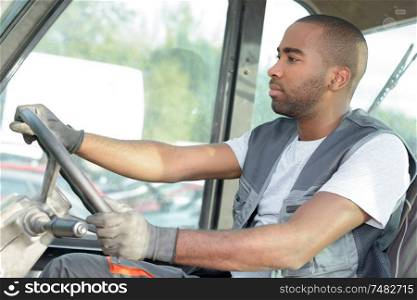 portrait of man driving industrial vehicle