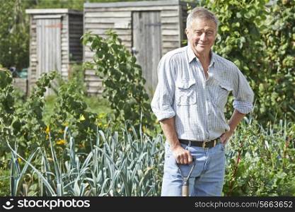 Portrait Of Man Gardening On Allotment