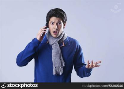 Portrait of man gesturing while talking on phone