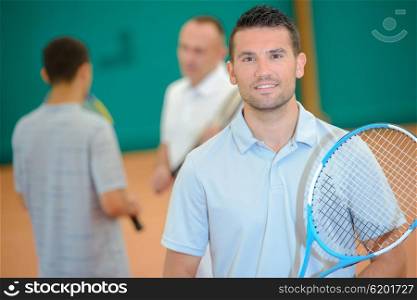Portrait of man holding tennis racket