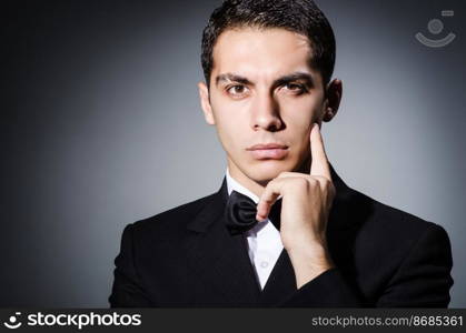 Portrait of man in dark studio