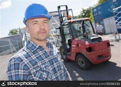Portrait of man in front of forklift