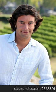 Portrait of man in front of vineyards