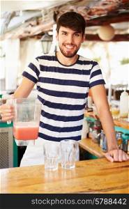 Portrait Of Man In Restaurant Making Fruit Smoothies