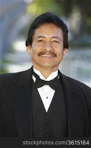 Portrait of man in tuxedo outdoors