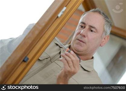 portrait of man in uniform working with screwdriver