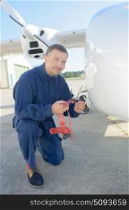 portrait of man inspecting the plane