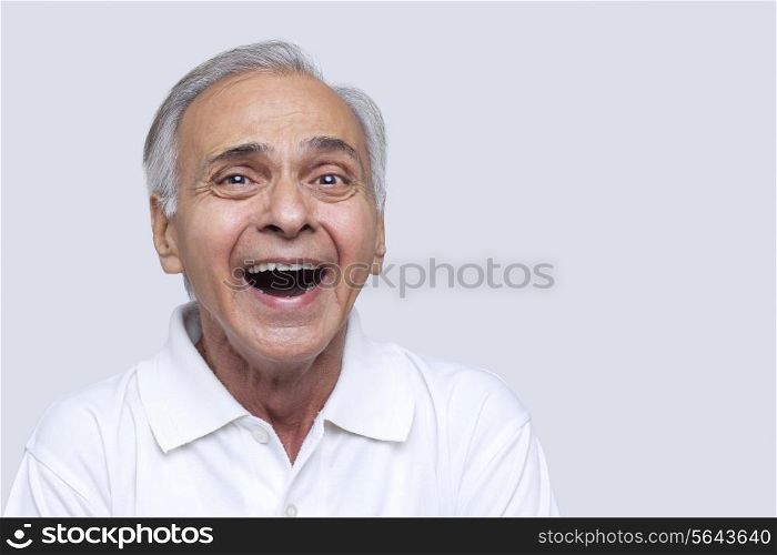 Portrait of man laughing over white background