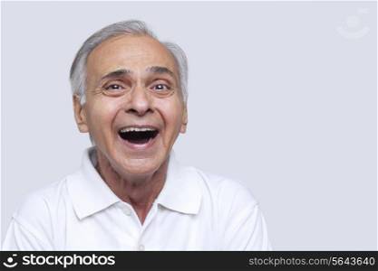 Portrait of man laughing over white background