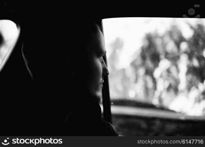 Portrait of man looking out the car window