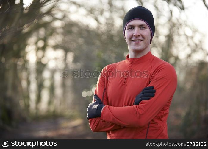 Portrait Of Man On Winter Run Through Woodland