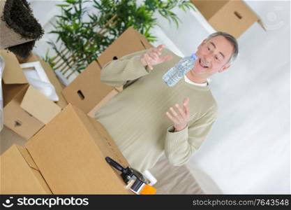 portrait of man packing boxes