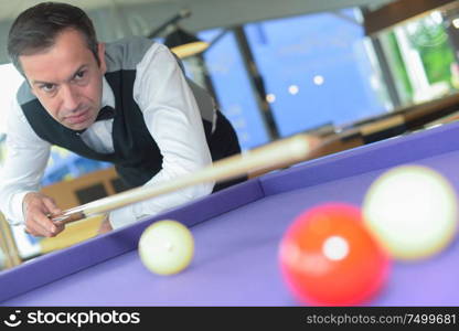 portrait of man playing pool