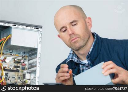 portrait of man repairing computer