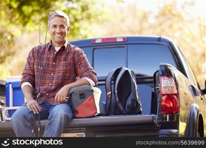 Portrait Of Man Sitting In Pick Up Truck On Camping Holiday