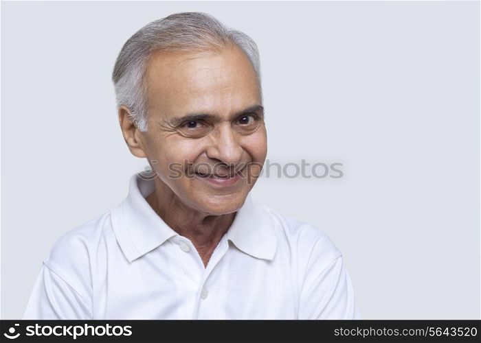 Portrait of man smiling over white background