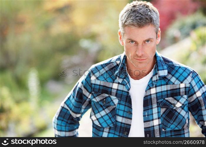 Portrait Of Man Standing Outside In Autumn Landscape