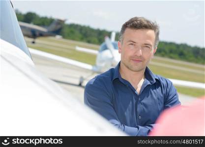 Portrait of man stood next to aircraft