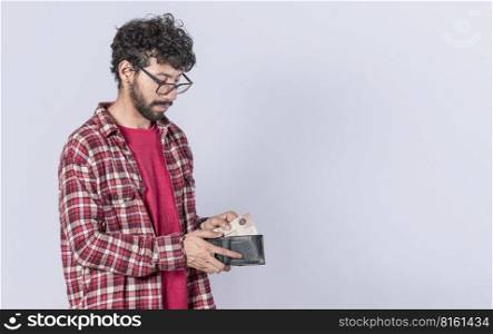 Portrait of man taking money out of his wallet, on isolated background, Person taking money out of his wallet on isolated background with copy space