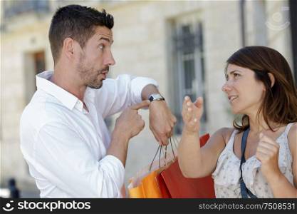 portrait of man telling off wife for being late