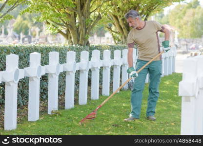 portrait of man upkeeping the cemetery