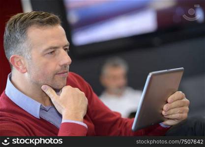portrait of man using tablet computer