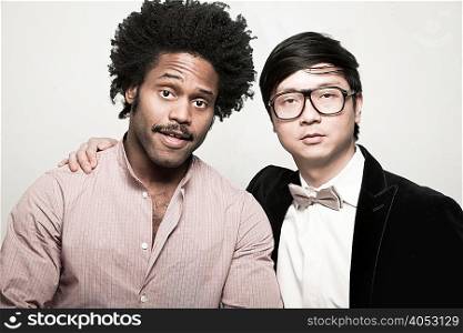 Portrait of man with afro and man wearing bow tie