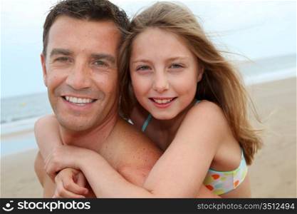 Portrait of man with daughter on his back