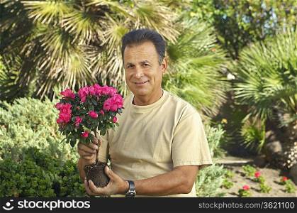 Portrait of man with flowers in garden