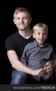 Portrait of man with son in studio