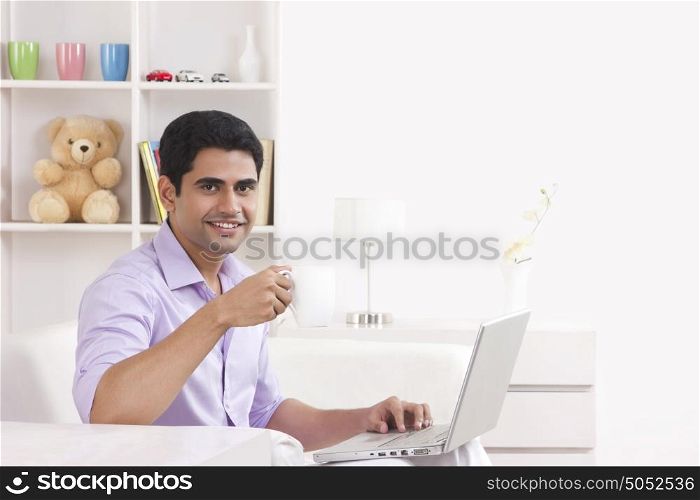Portrait of man working on laptop