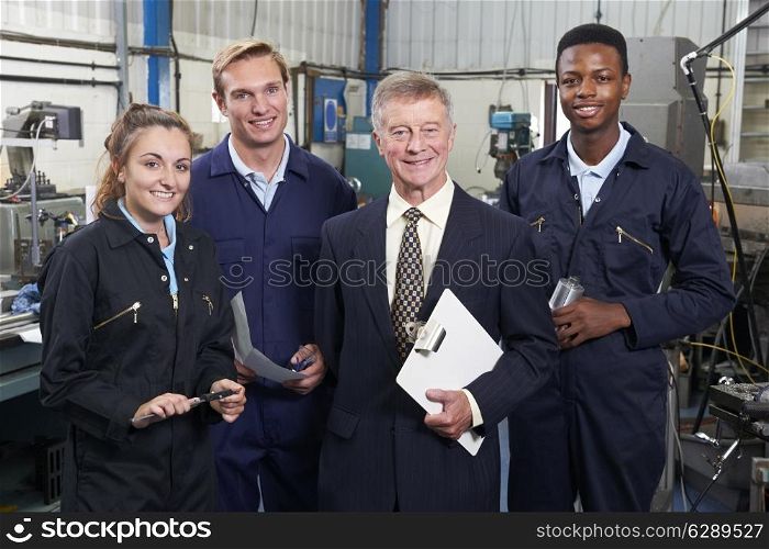 Portrait Of Manager And Staff In Engineering Factory