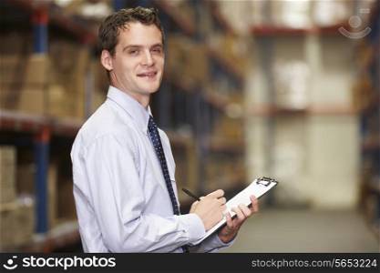 Portrait Of Manager In Warehouse With Clipboard