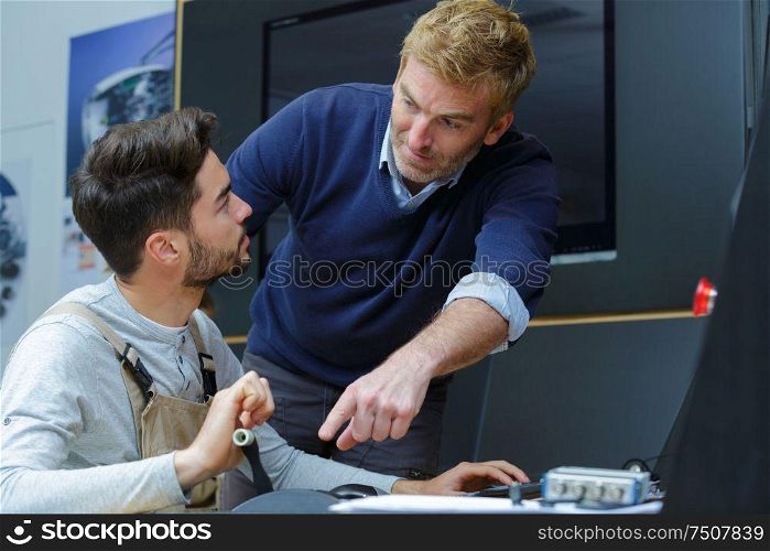 portrait of manager with apprentice talking