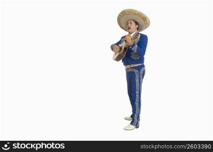 Portrait of Mariachi playing guitar and singing