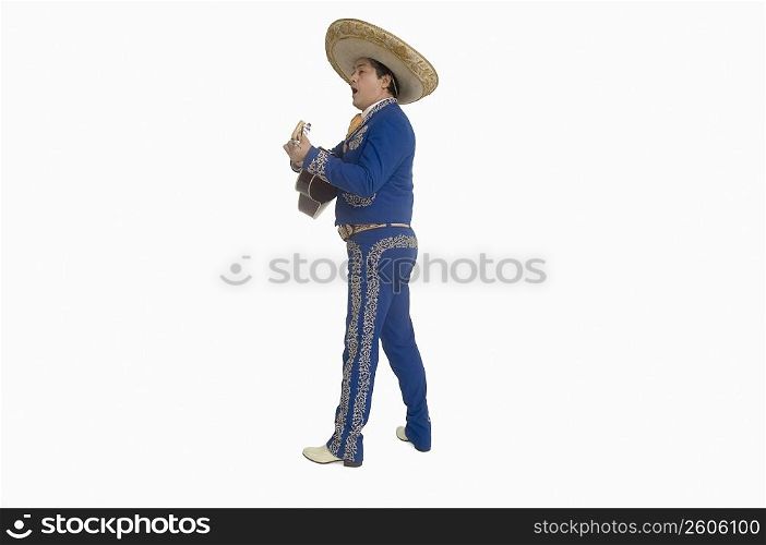 Portrait of Mariachi playing guitar and singing