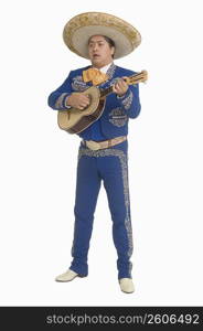 Portrait of Mariachi playing guitar and singing