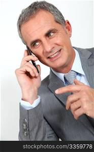 Portrait of mature businessman on the phone
