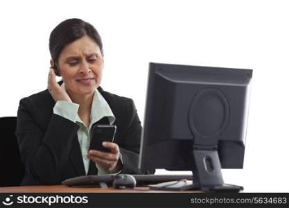 Portrait of mature businesswoman answering phone call