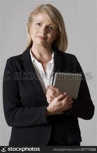 Portrait Of Mature Businesswoman Holding Digital Tablet