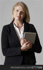 Portrait Of Mature Businesswoman Holding Digital Tablet